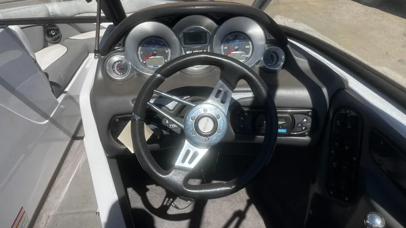 Slide: The Image of 2007 Supra Sunsport 22 V boat dashboard with steering wheel and gauges. - 8