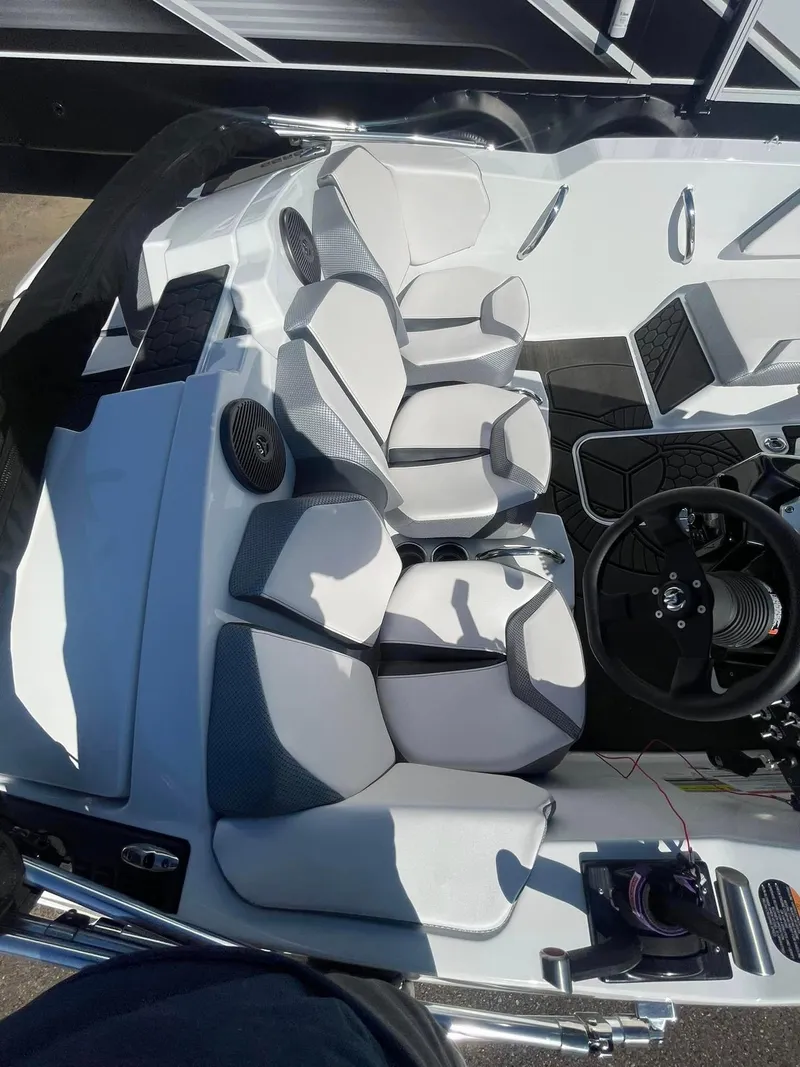 Slide: The Image of 2022 Scarab 165 SE boat interior with modern seating and steering wheel. - 4