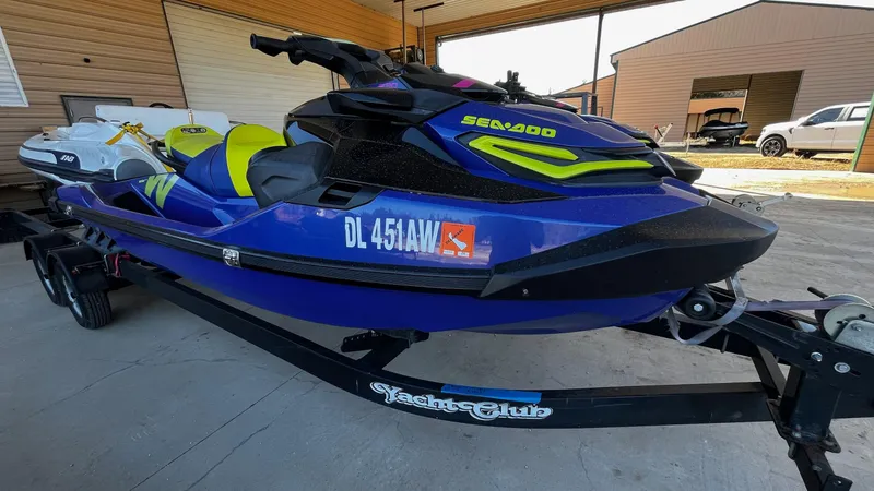 Slide: The Image of 2021 Sea-Doo Wake Pro 230 jet ski on trailer, blue and yellow design. - 2