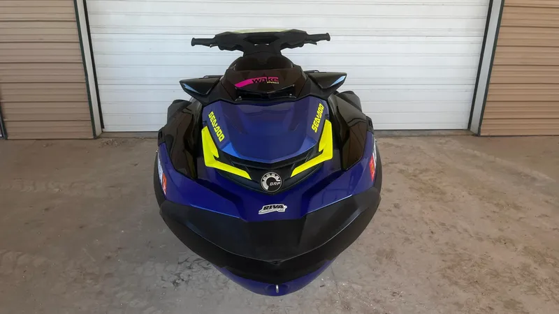 Slide: The Image of 2021 Sea-Doo Wake Pro 230 jet ski, blue and yellow, front view in garage. - 4