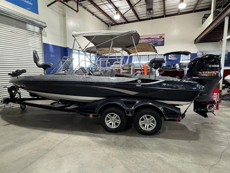 Slide: The Image of 2018 Ranger 212LS boat with canopy and Yamaha engine in a showroom. - 1
