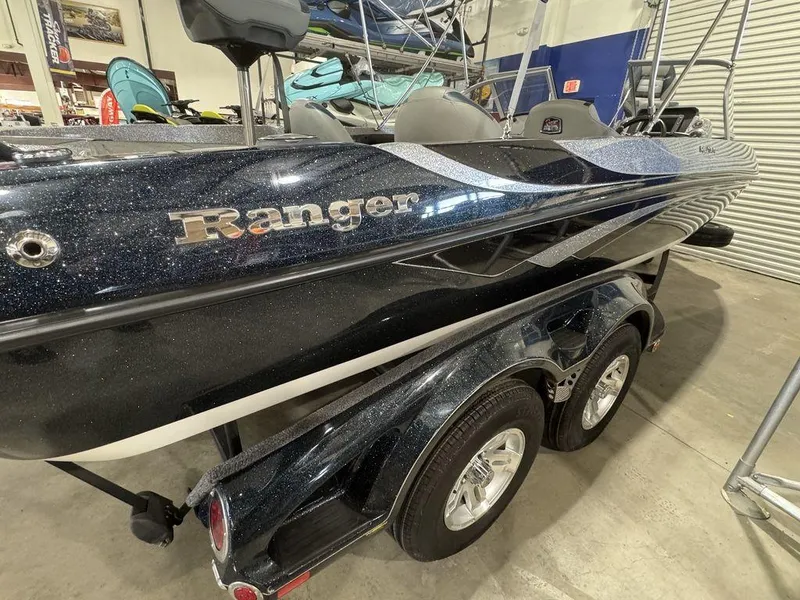 Slide: The Image of 2018 Ranger 212LS boat on trailer in showroom, featuring sleek design and metallic finish. - 12