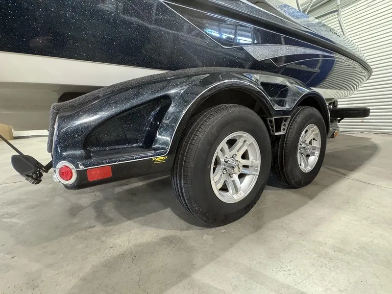 Slide: The Image of 2018 Ranger 212LS boat trailer with dual wheels in a garage setting. - 13