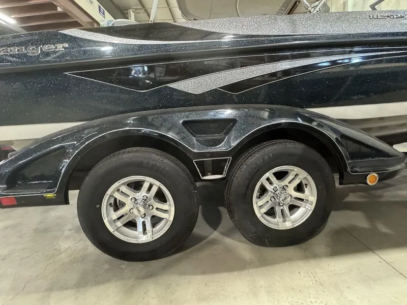 Slide: The Image of 2018 Ranger 212LS boat trailer with dual wheels and sleek black design. - 14