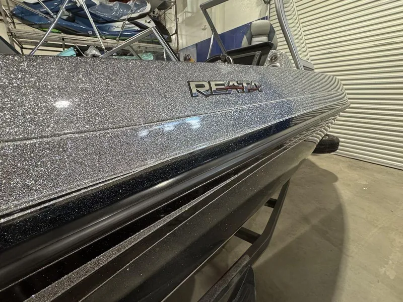 Slide: The Image of 2018 Ranger 212LS boat with metallic finish in a garage setting. - 16