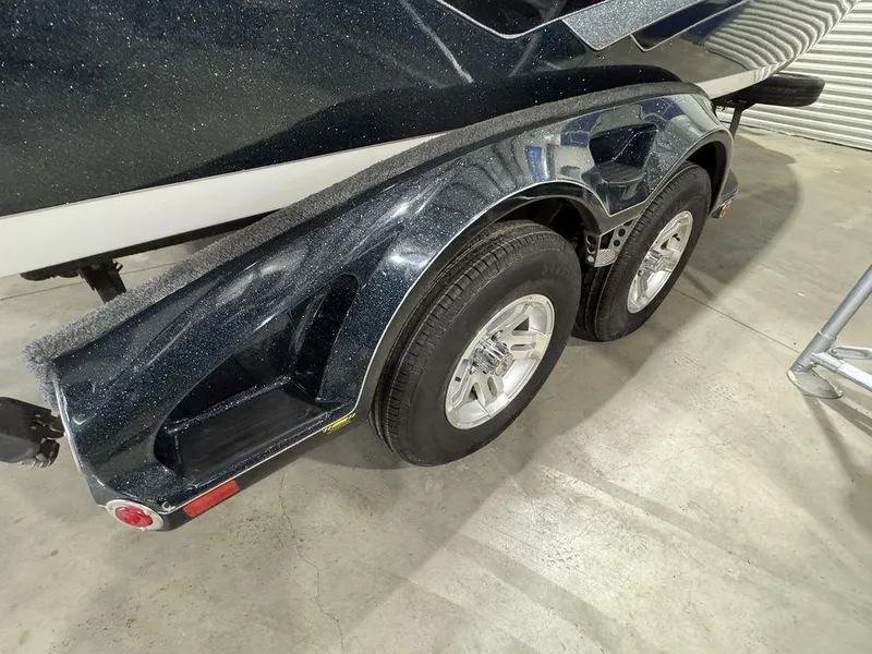 Slide: The Image of 2018 Ranger 212LS boat trailer with dual wheels in a garage setting. - 17