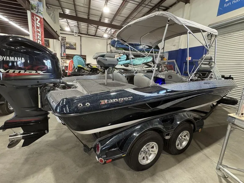 Slide: The Image of 2018 Ranger 212LS boat with Yamaha outboard motor in a showroom. - 18