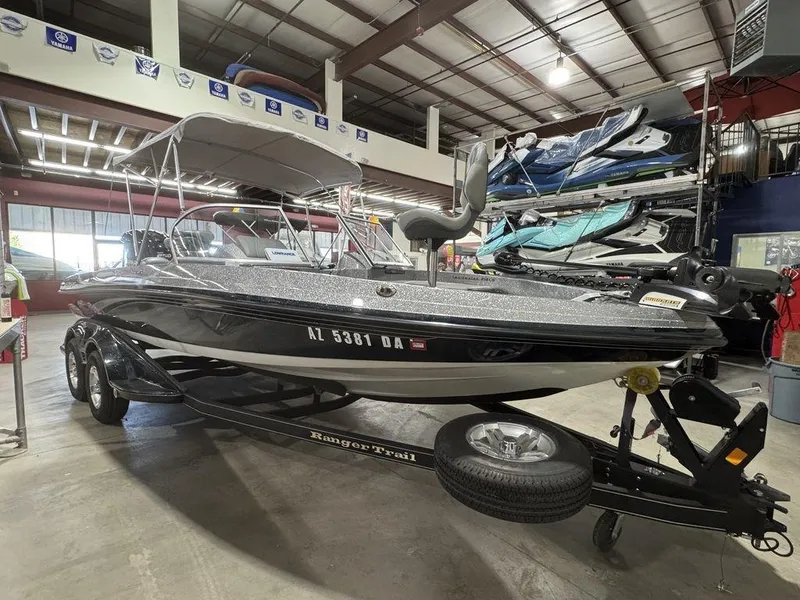 Slide: The Image of 2018 Ranger 212LS boat in showroom, black exterior, on trailer, indoor storage. - 19