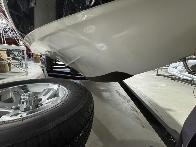 Slide: The Image of 2018 Ranger 212LS boat hull and trailer wheel in a storage facility. - 23