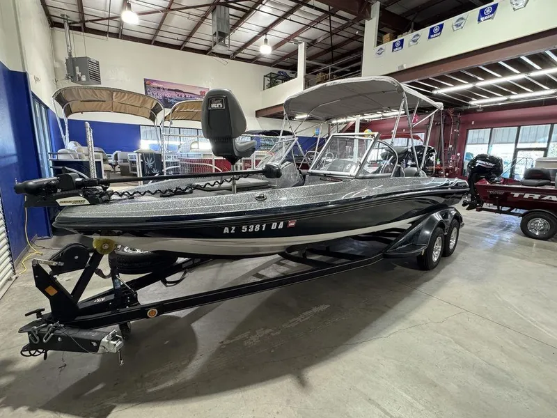 Slide: The Image of 2018 Ranger 212LS boat in showroom, featuring sleek design and canopy. - 3