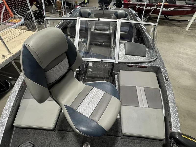 Slide: The Image of 2018 Ranger 212LS boat interior with gray and blue seating, windshield, and storage compartments. - 31