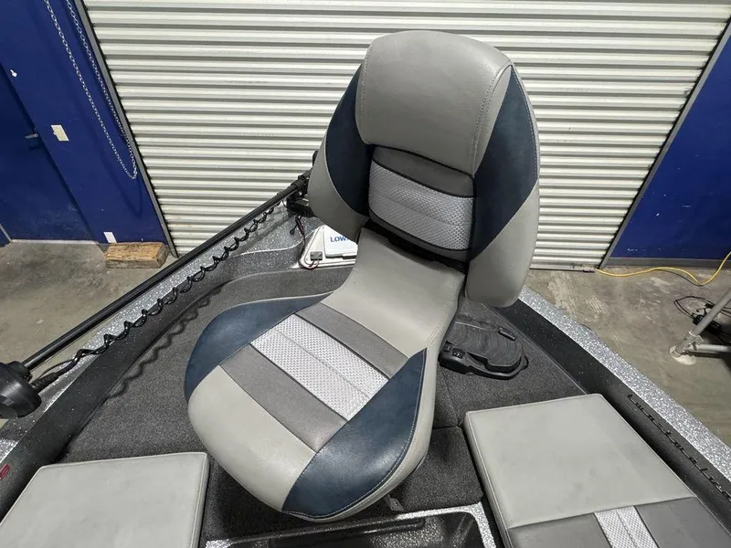 Slide: The Image of 2018 Ranger 212LS boat seat with gray and blue upholstery in a garage setting. - 34