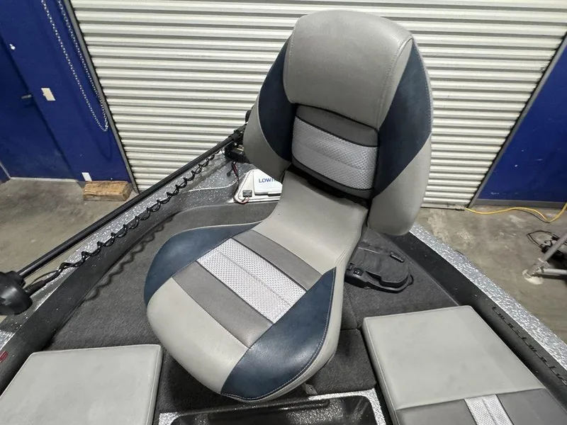 Slide: The Image of 2018 Ranger 212LS boat seat with gray and blue upholstery in a garage setting. - 36