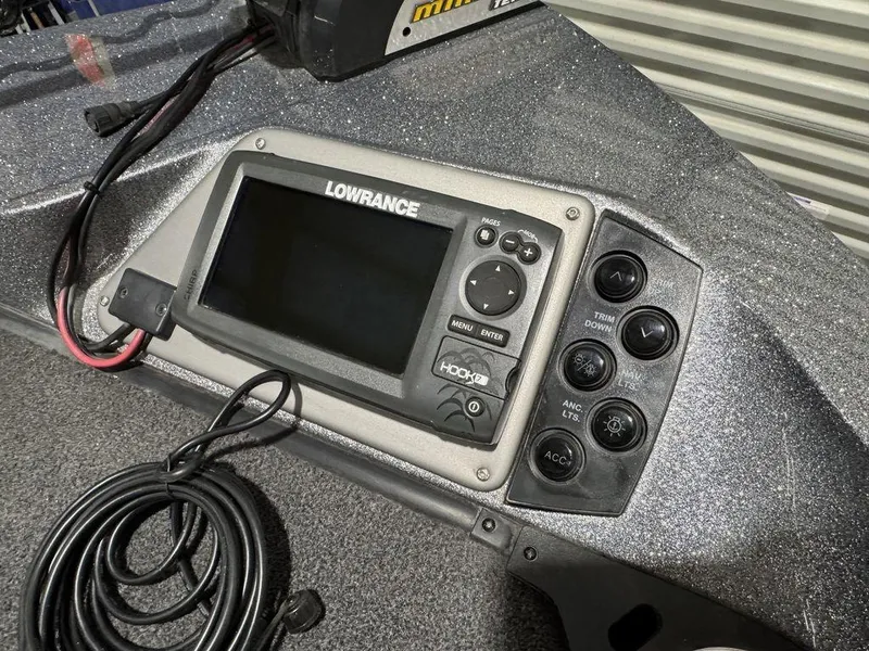 Slide: The Image of Lowrance fishfinder on 2018 Ranger 212LS boat dashboard with control panel and coiled cable. - 40