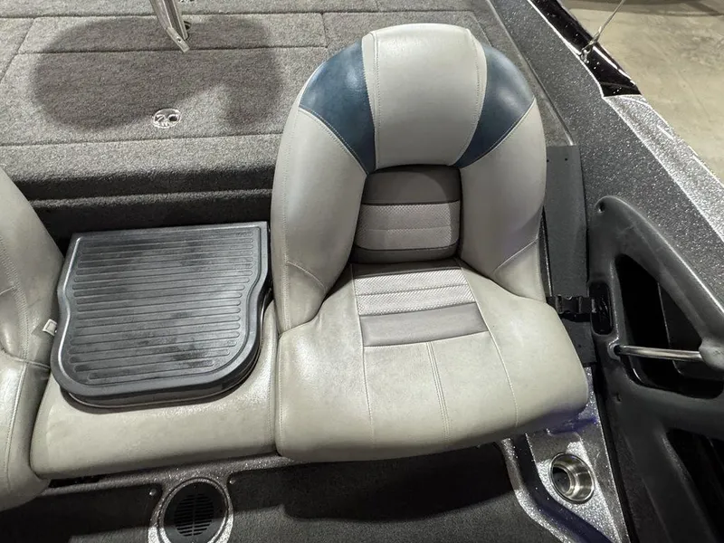 Slide: The Image of 2018 Ranger 212LS boat seat with gray and blue upholstery, featuring a textured footrest. - 45