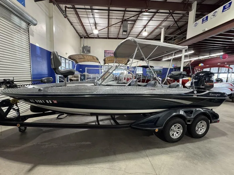 Slide: The Image of 2018 Ranger 212LS boat in showroom, featuring dual seats and a canopy. - 8