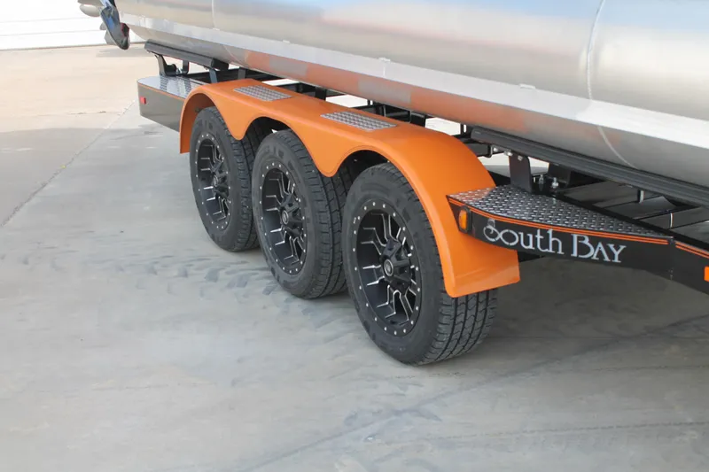 Slide: The Image of 2024 South Bay 25 Sport CR9-DC trailer with triple axle and orange fenders. - 13