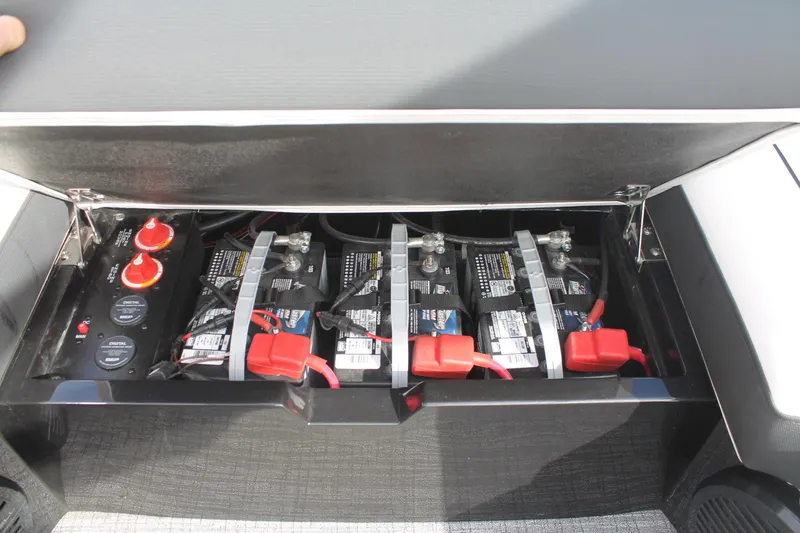 Slide: The Image of Battery compartment of 2024 South Bay 25 Sport CR9-DC boat, featuring multiple batteries and wiring. - 14