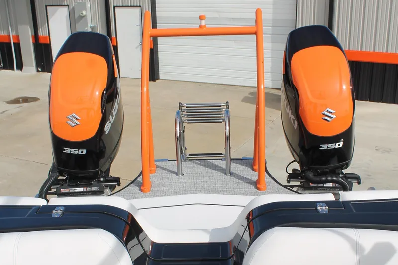 Slide: The Image of 2024 South Bay 25 Sport CR9-DC boat with dual Suzuki 350 engines, docked outdoors. - 3
