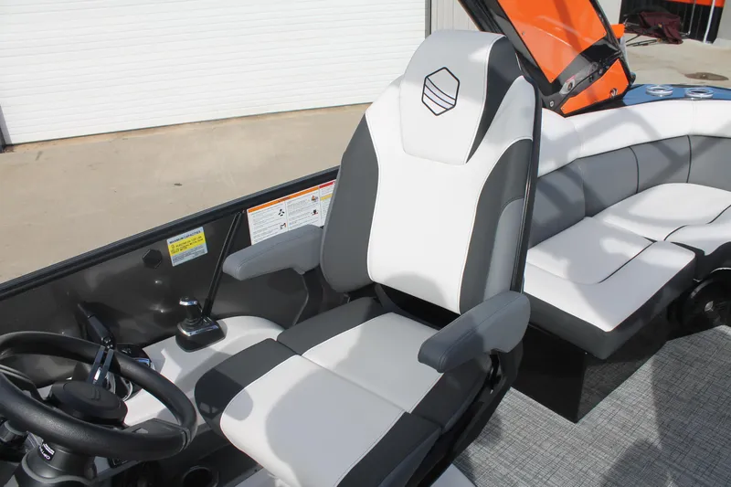 Slide: The Image of 2024 South Bay 25 Sport CR9-DC boat interior with modern seating and steering wheel. - 8