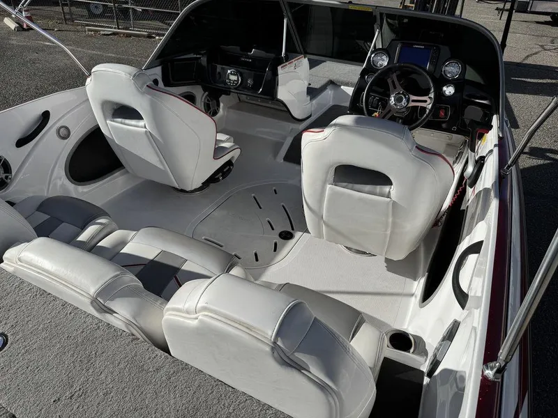 Slide: The Image of 2018 Nitro Z19 Sport boat interior with white seating and modern dashboard. - 10