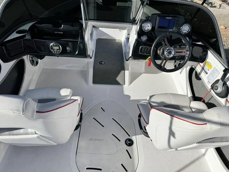 Slide: The Image of Interior of a 2018 Nitro Z19 Sport boat with dual seats and control panel. - 12