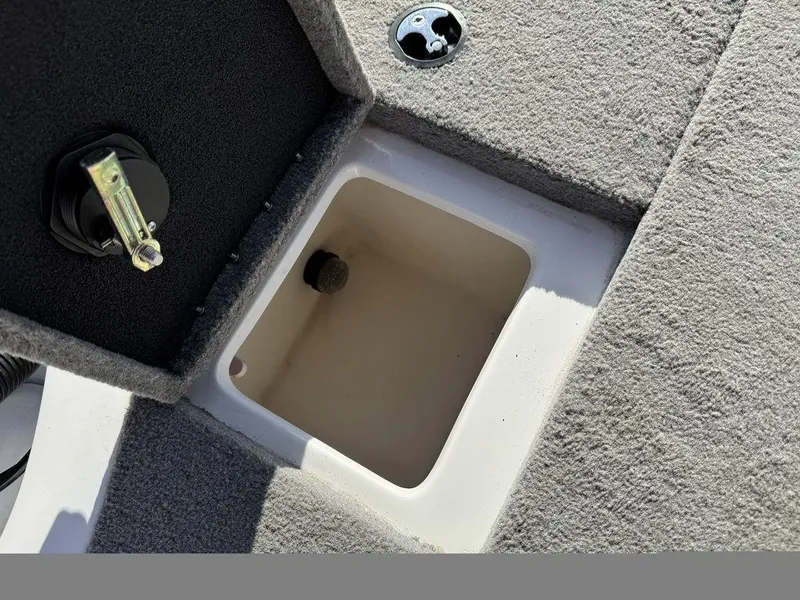 Slide: The Image of 2018 Nitro Z19 Sport boat storage compartment with open lid, showcasing interior details. - 13