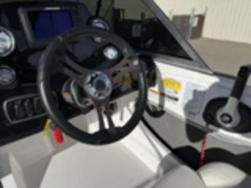 Slide: The Image of 2018 Nitro Z19 Sport boat dashboard with steering wheel and controls. - 18