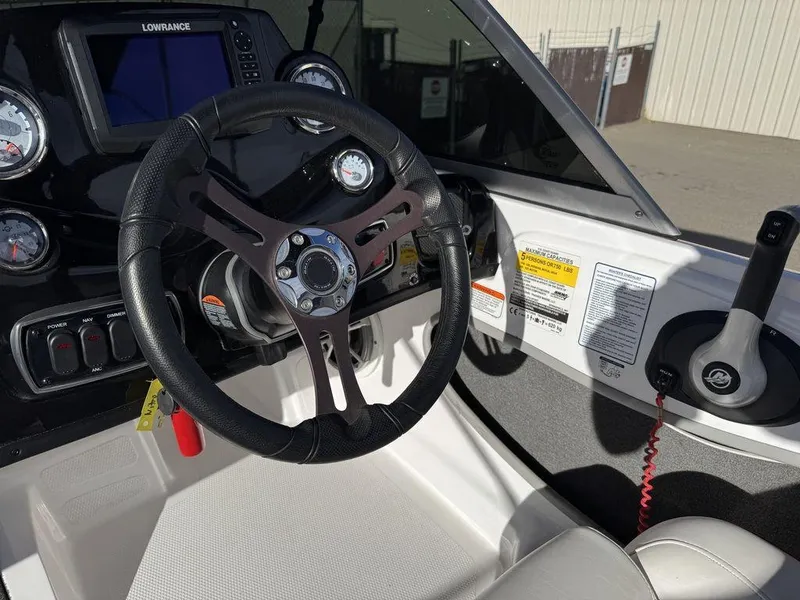 Slide: The Image of 2018 Nitro Z19 Sport boat dashboard with steering wheel and control panel. - 20