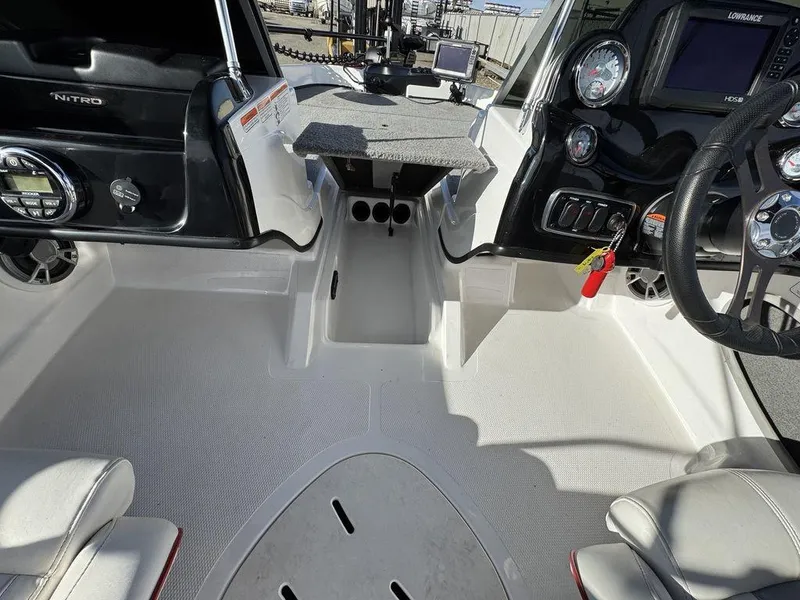 Slide: The Image of 2018 Nitro Z19 Sport boat interior with steering wheel, dashboard, and seating area. - 23