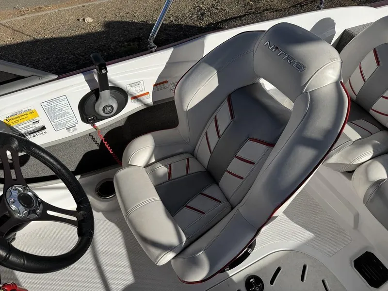 Slide: The Image of 2018 Nitro Z19 Sport boat seat with steering wheel, featuring sleek design and comfortable upholstery. - 27