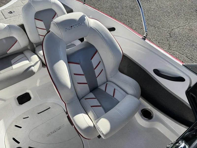 Slide: The Image of 2018 Nitro Z19 Sport boat interior with gray and red-accented seating. - 28