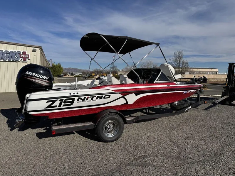 Slide: The Image of 2018 Nitro Z19 Sport boat with Mercury engine, parked outdoors under a clear sky. - 3
