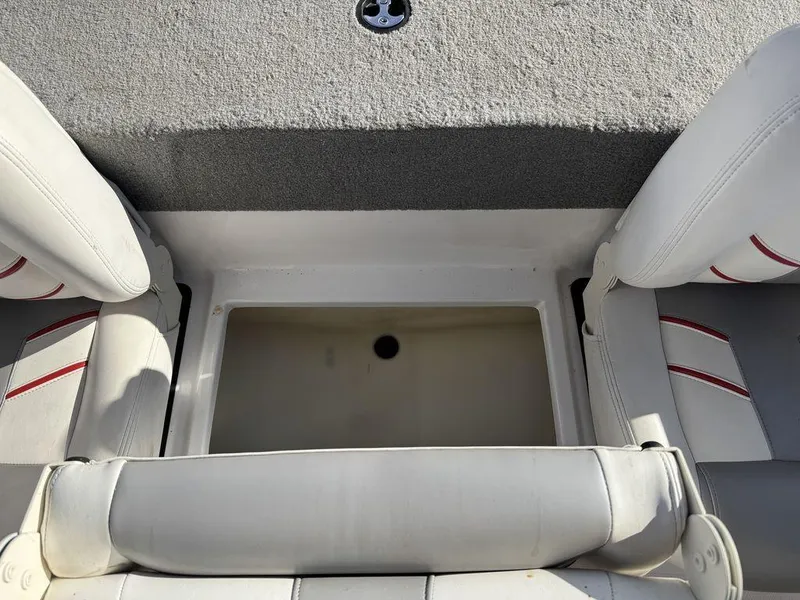 Slide: The Image of 2018 Nitro Z19 Sport boat interior with storage compartment and cushioned seating. - 35