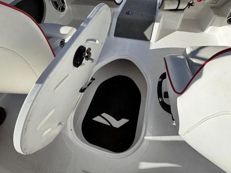 Slide: The Image of 2018 Nitro Z19 Sport boat interior with open storage compartment and seating. - 37