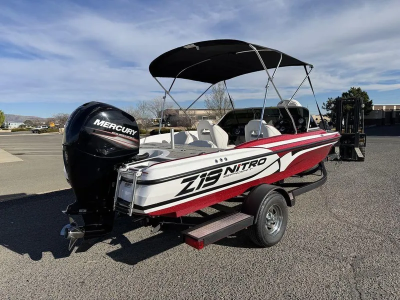 Slide: The Image of 2018 Nitro Z19 Sport boat with Mercury engine on trailer, parked outdoors. - 4