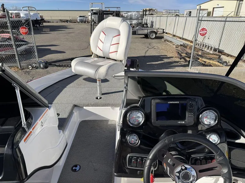 Slide: The Image of 2018 Nitro Z19 Sport boat interior with steering wheel and seat, parked in a lot. - 40