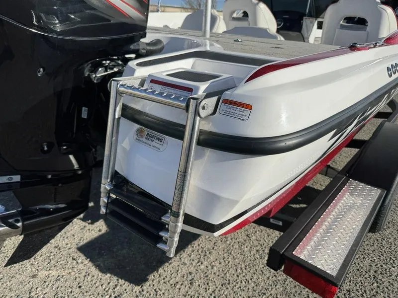 Slide: The Image of 2018 Nitro Z19 Sport boat with ladder and motor, parked on a trailer. - 41