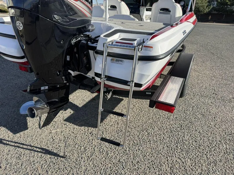 Slide: The Image of 2018 Nitro Z19 Sport boat with ladder and motor, parked on a trailer. - 43