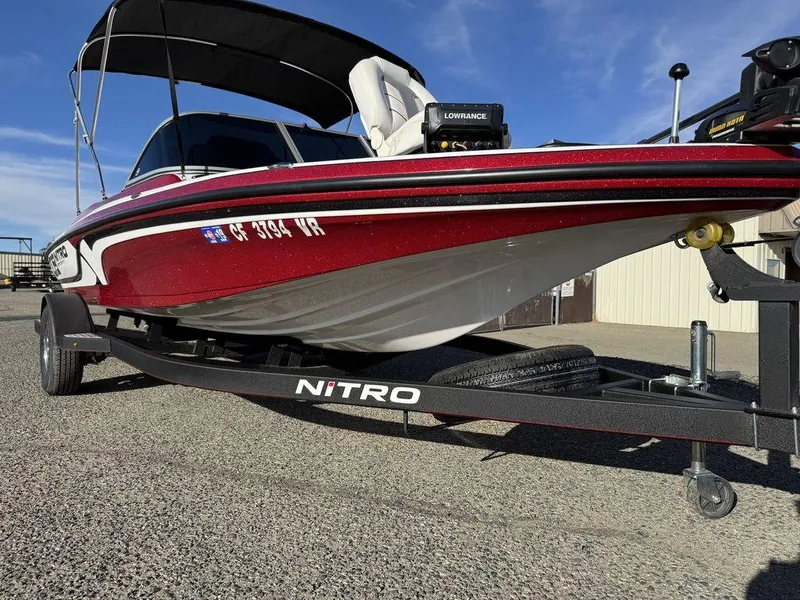 Slide: The Image of 2018 Nitro Z19 Sport boat on trailer, red and white design, parked outdoors. - 46