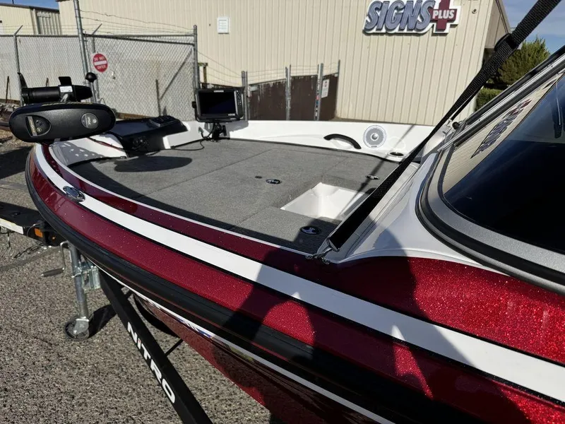 Slide: The Image of 2018 Nitro Z19 Sport boat with red and white detailing, parked outdoors. - 5