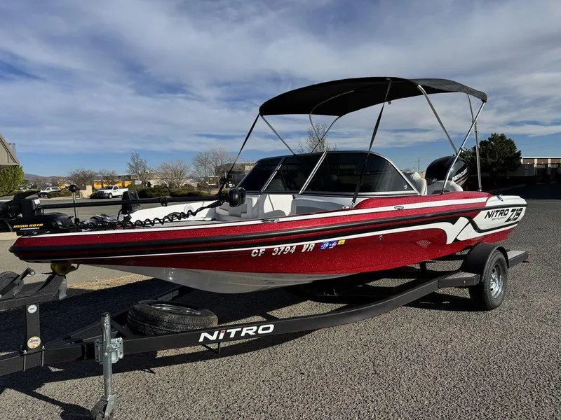 Slide: The Image of 2018 Nitro Z19 Sport boat with canopy on trailer, parked outdoors. - 6