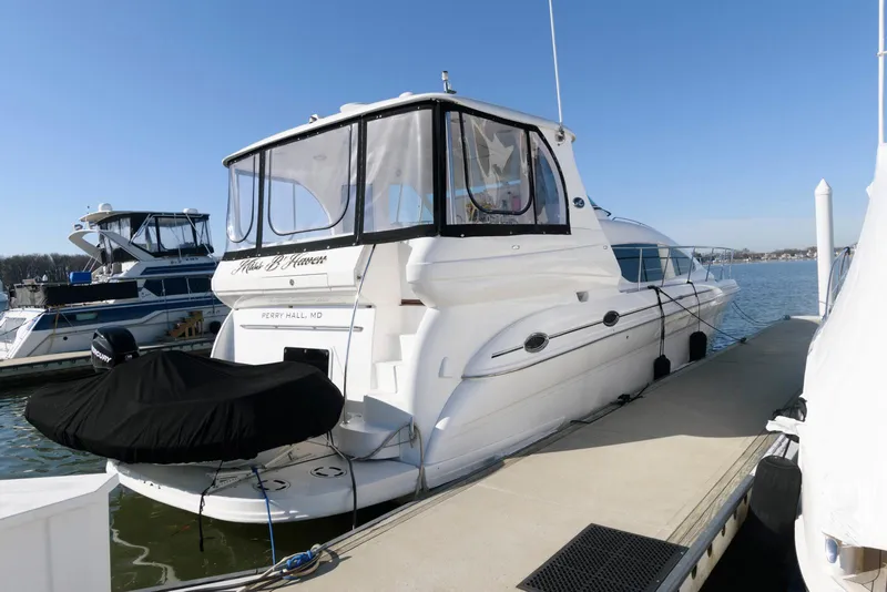 Slide: The Image of 2002 Sea Ray 480 Motor Yacht docked at marina under clear blue sky. - 1