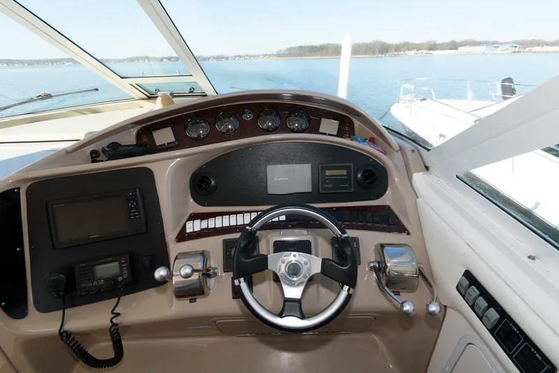 Slide: The Image of 2002 Sea Ray 480 Motor Yacht helm with steering wheel and navigation controls. - 11