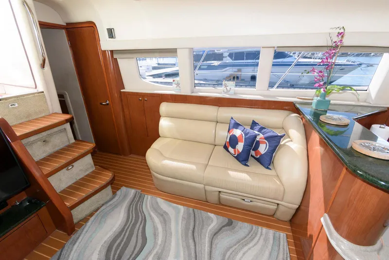 Slide: The Image of Luxurious interior of 2002 Sea Ray 480 Motor Yacht with leather sofa and nautical decor. - 15