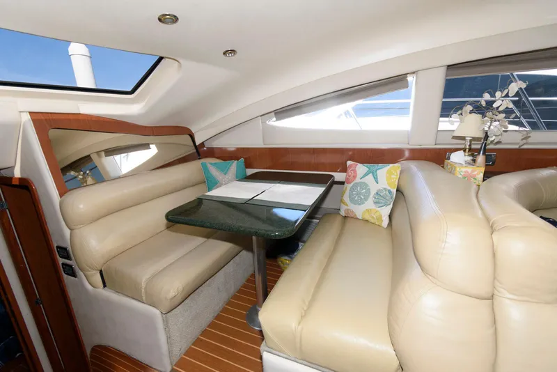 Slide: The Image of Interior of 2002 Sea Ray 480 Motor Yacht with beige seating and dining table. - 19
