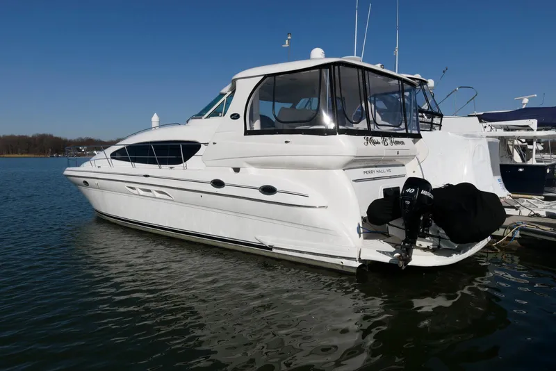 Slide: The Image of 2002 Sea Ray 480 Motor Yacht docked on calm water. - 2