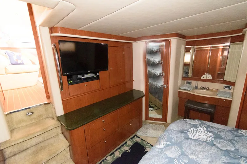 Slide: The Image of 2002 Sea Ray 480 Motor Yacht interior with TV, cabinetry, and bed. - 21
