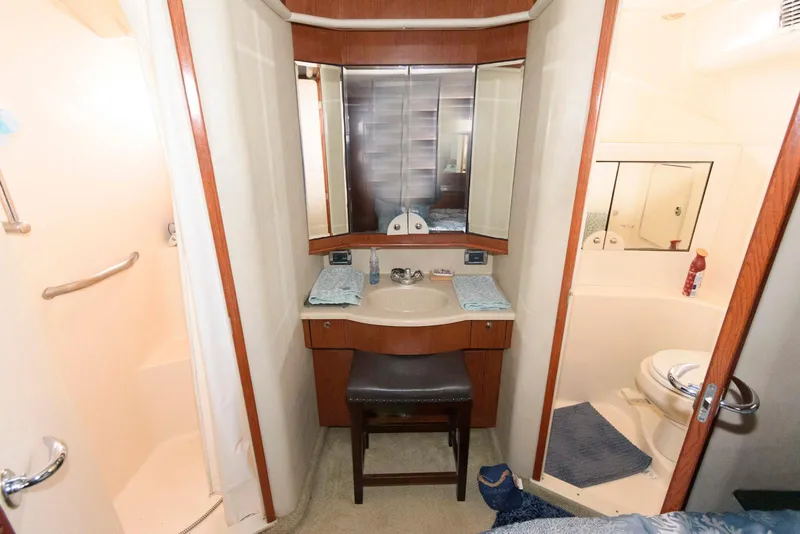 Slide: The Image of 2002 Sea Ray 480 Motor Yacht bathroom with vanity, shower, and toilet. - 22