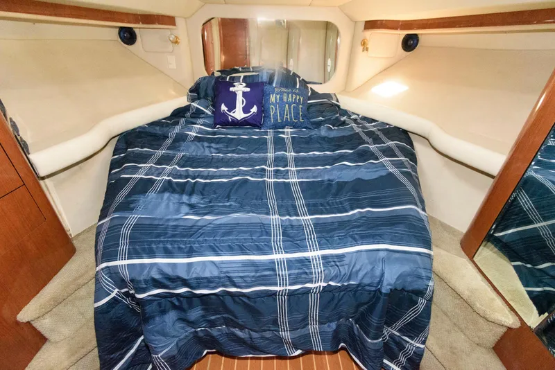 Slide: The Image of Luxurious 2002 Sea Ray 480 Motor Yacht bedroom with nautical-themed bedding. - 23